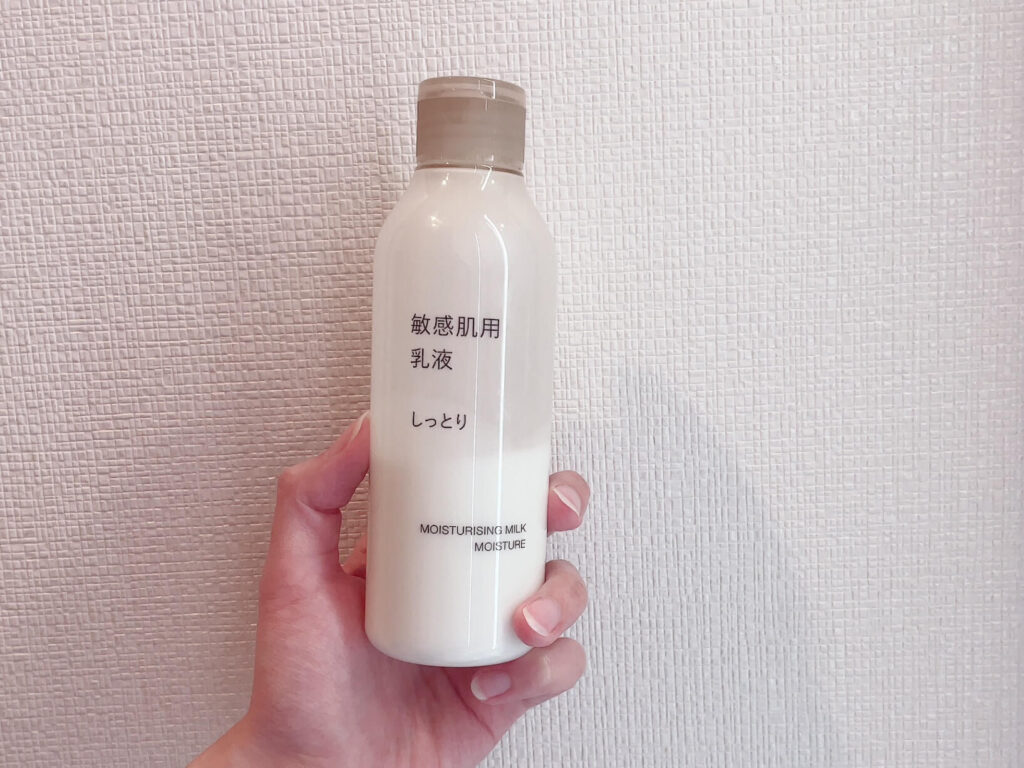 MUJI Sensitive Skin Milk Moist bottle held in hand